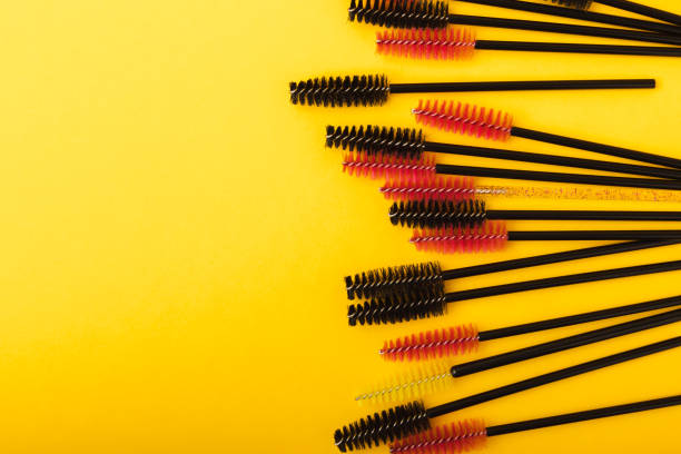istock Mascara brushes, makeup brushes, applicator and false eyelashes on a colored background. close-up. Brushes for eyelash extensions. Fashion. The concept of the beauty industry. 1464206653