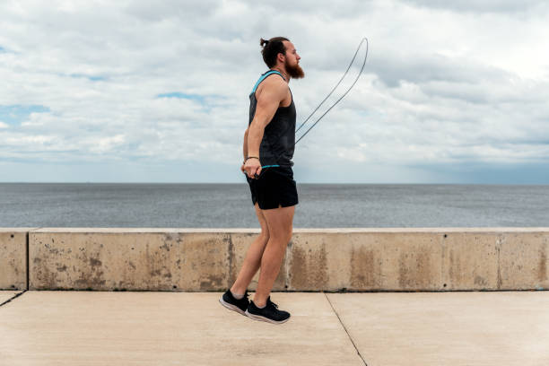 istock Young Man Exercising Near the Coast 1464207202