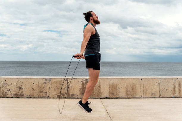 istock Young Man Exercising Near the Coast 1464207290
