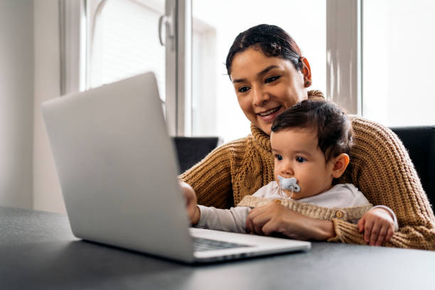 istock Mom and her Baby Using Laptop 1464207320