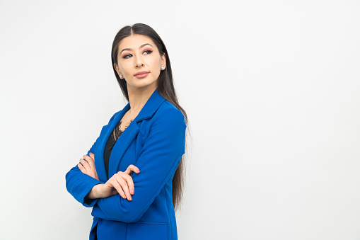 Portrait of young asian business woman on plain background