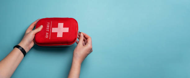 istock A woman opens a first aid kit. Home first aid kit on a blue 1464217134