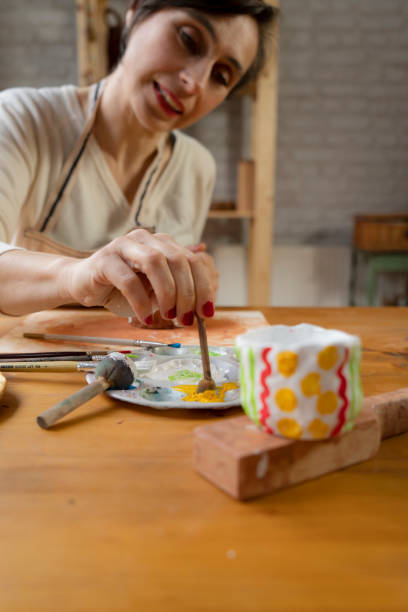 istock Woman painting a pottery 1464217656