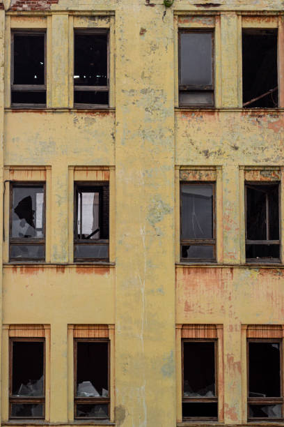 istock Broken windows in the old yellow house. 1464221436