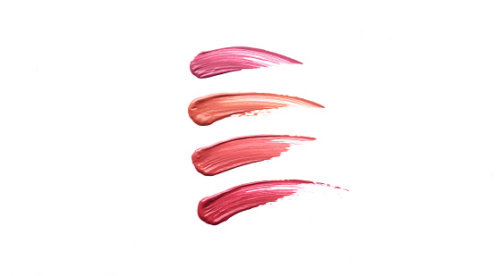 Lip gloss or lipstick swatches isolated on white background. Trendy lipstick gloss colors smudge samples. Space for text