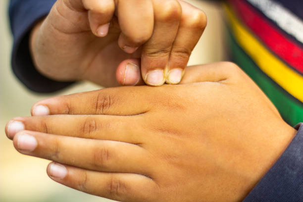 istock two human hands holding each other on another hand and the background is blurred 1464222088