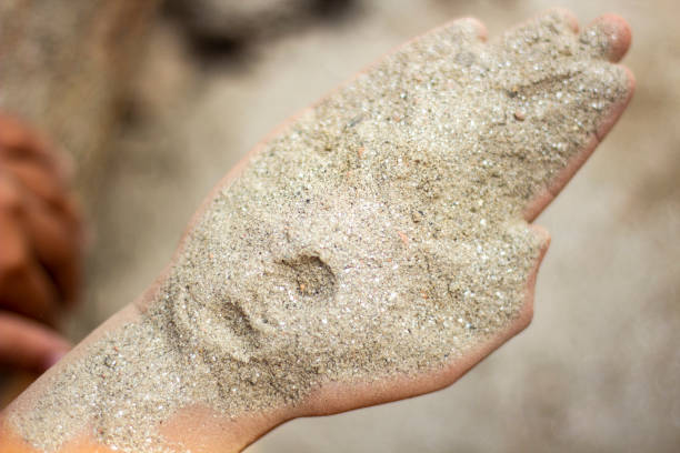 istock A boy is playing with sand in his hands and the background is blurred 1464223256