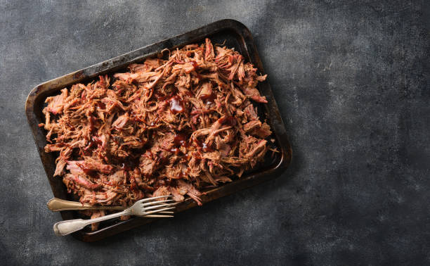 istock Traditional barbecue pulled pork. Slow cooked pulled pork shoulder. Juicy pork meat cooked in a smoker by low and slow 1464223627