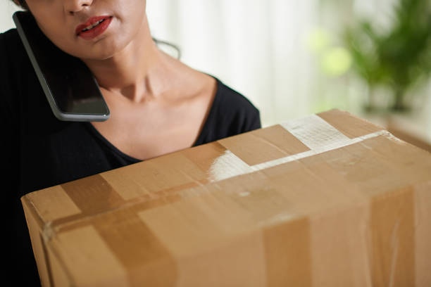 istock Woman Calling to Moving Company 1464225130