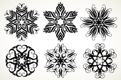 Set of ornate lacy doodle floral round rosettes in black over white backgrounds. Mandalas formed with hand drawn calligraphic elements.