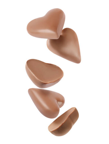 istock Delicious heart shaped chocolate candies falling on white background 1464236752