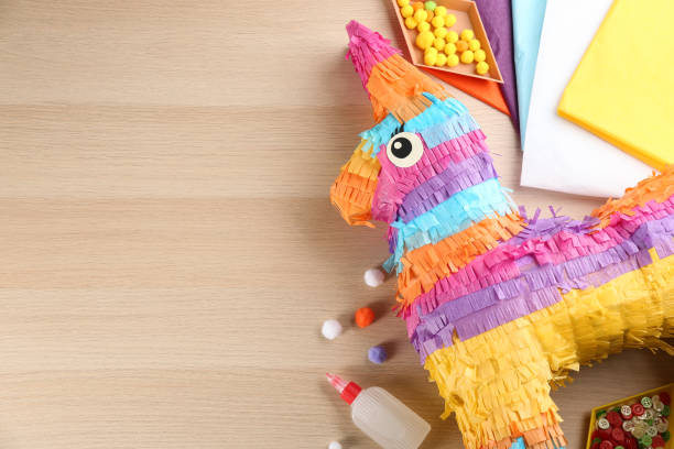 istock Flat lay composition with cardboard donkey on wooden table, space for text. Pinata diy 1464237495