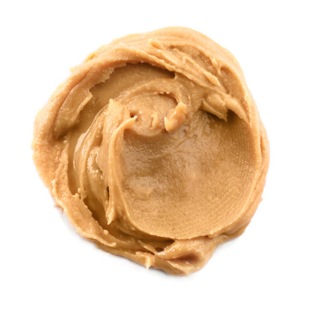 istock Delicious peanut butter isolated on white, top view 1464237590