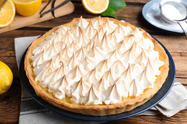 istock Delicious lemon meringue pie on wooden table, closeup 1464237682