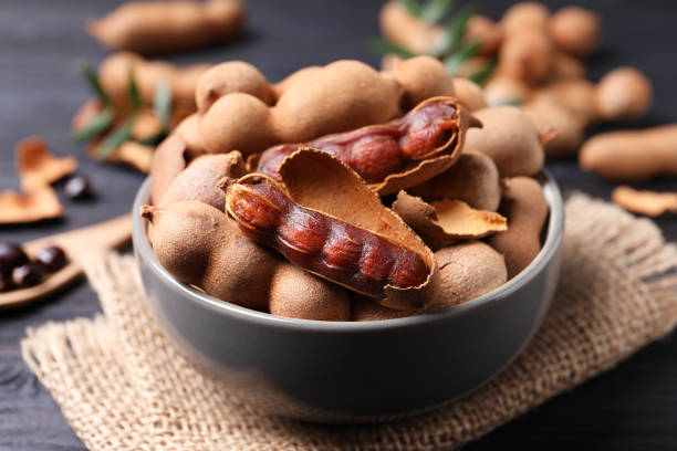 istock Delicious ripe tamarinds in ceramic bowl on table, closeup 1464237731