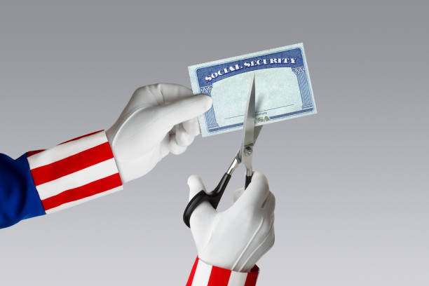 Social Security Cuts Uncle Sam uses a pair of scissors to cut a Social Security card that he is holding. uncle sam broke stock pictures, royalty-free photos & images