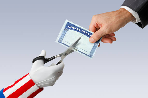 Social Security Cuts Uncle Sam uses a pair of scissors to cut a Social Security card that is being held by a man. uncle sam broke stock pictures, royalty-free photos & images
