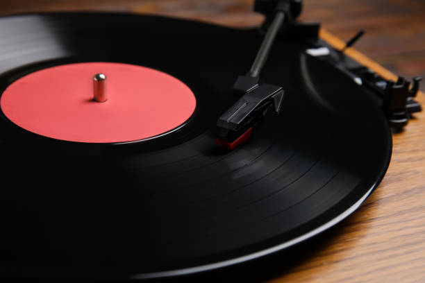 istock Modern vinyl record player with disc on table, closeup 1464240360