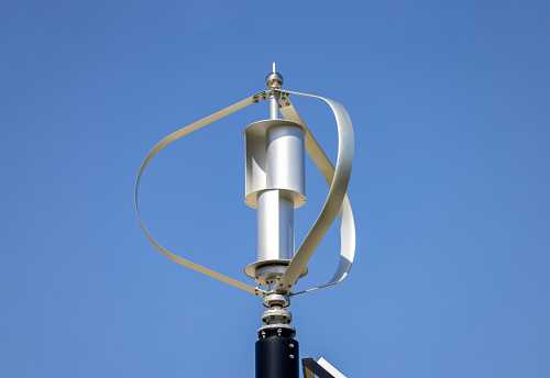 Closeup small Wind turbine, blue sky background with copy space, full frame horizontal composition