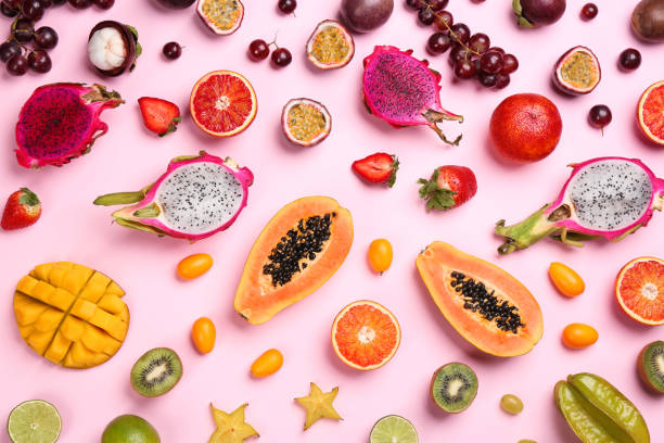 istock Many different delicious exotic fruits on pink background, flat lay 1464240567