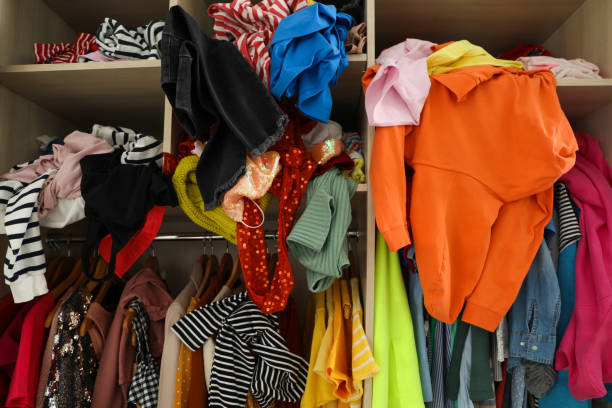istock Messy wardrobe with different clothes. Fast fashion concept 1464240616