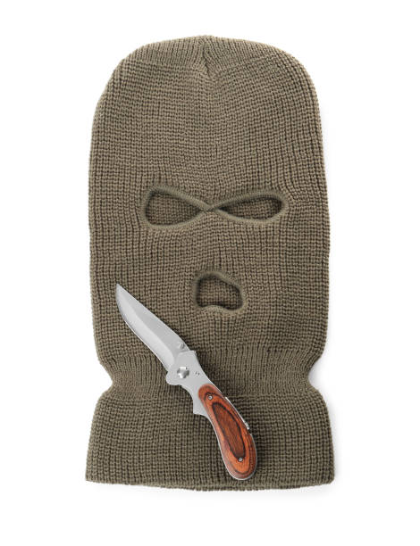 istock Beige knitted balaclava and knife on white background, top view 1464240796