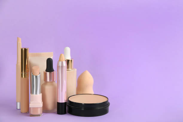 istock Foundation makeup products on violet background, space for text. Decorative cosmetics 1464241534