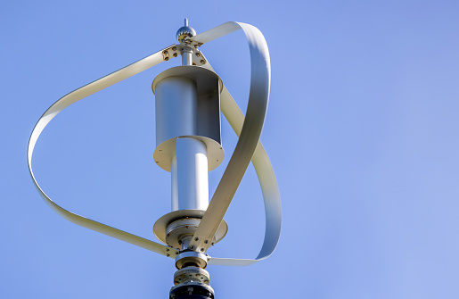 Closeup small Wind turbine, blue sky background with copy space, full frame horizontal composition