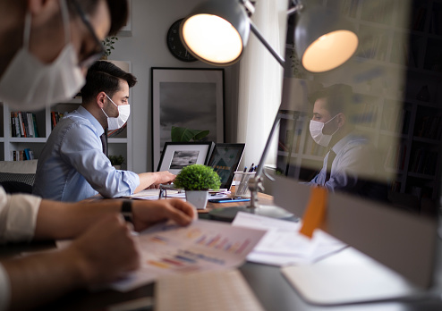 Two young businessmen or plan project in office