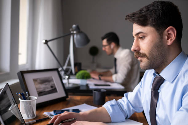 istock Two young businessmen or plan project in office 1464243546