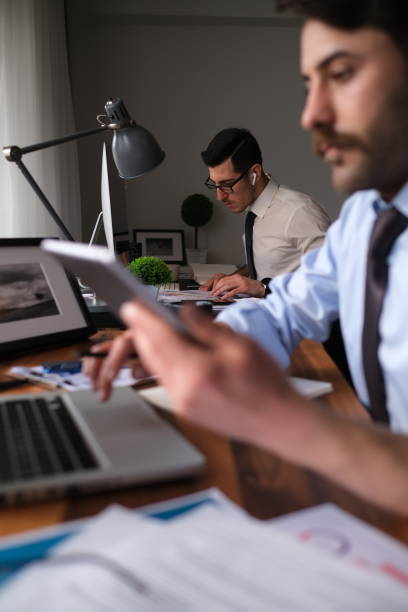 istock Two young businessmen or plan project in office 1464243571