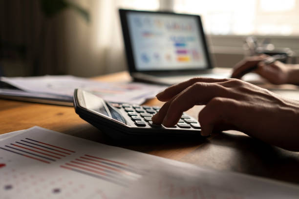 istock Business accounting concept, Business man using calculator with computer laptop, budget and loan paper in office. 1464245435