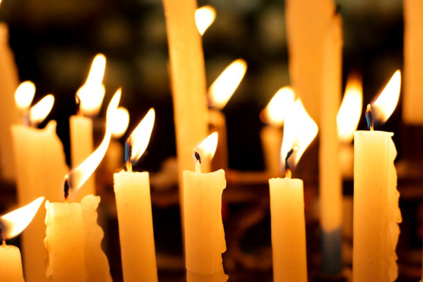 istock Close-up of several candles lit inside a church. 1464246061