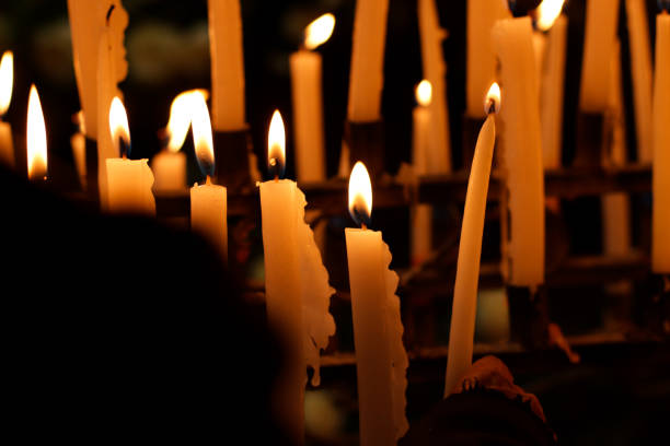 istock Close-up of several candles lit inside a church. 1464246077