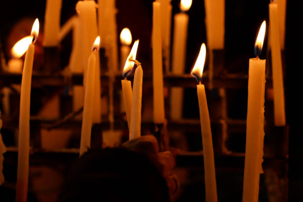 istock Close-up of several candles lit inside a church. 1464246092