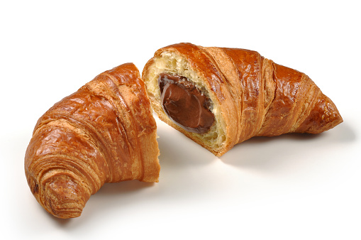 Croissant cut in half with chocolate cream isolated on white background