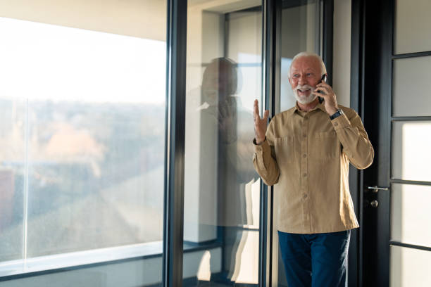 istock Cheerful pensioner talking on smart phone 1464249487