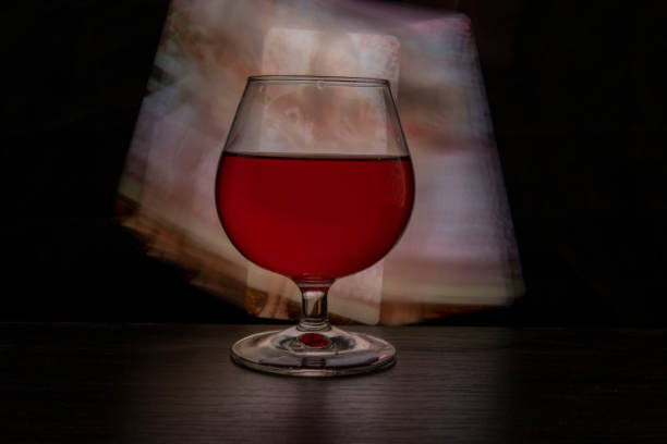 A glass of wine on a colored background