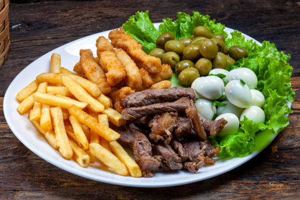 istock Snacks with fries, meat Picanha, quail egg, olives and breaded fish 1464250595