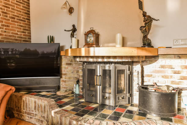 a living room with a brick fireplace and television set on the wall in front of the fireplace is made out of bricks