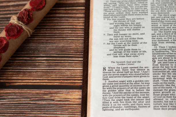 Revelation 8, open holy bible book on wooden table and old paper scroll with seven seals Revelation 8, open holy bible book on wooden table and old paper scroll with seven seals. Christian prophecy of Jesus Christ, the Lamb of God, judgment day, apocalypse concept. Armageddon Bible stock pictures, royalty-free photos & images