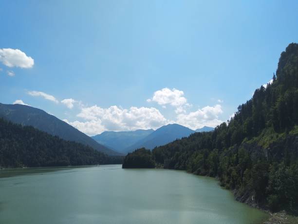 istock Green lake surrounded by mountains 1464255675