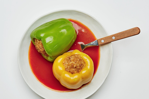 Stuffed peppers, cooked meal isolated on the white background, representing a healthy lifestyle, body car and wellbeing, table top view image with a copy space