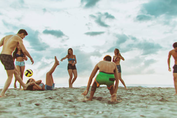 teenager friends at sea during summer - beach volleying ball playing imagens e fotografias de stock