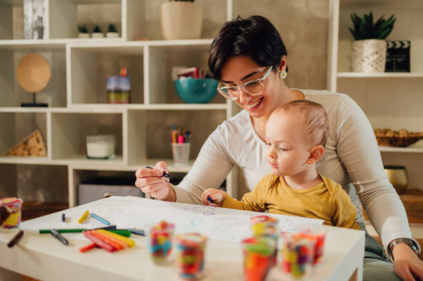 istock Mother and son drawing with crayons at home and creating art 1464257466