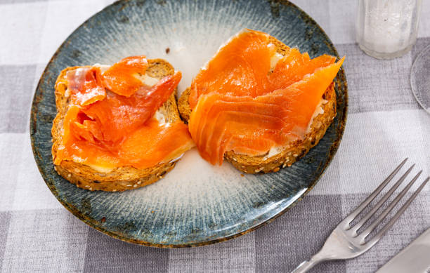 istock Two sandwiches with white bread butter and smoked salmon 1464258758