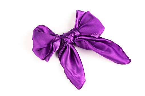 Purple silk tied bow on white background