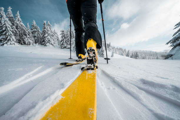 Close up on a boot and a ski during ski touring adventure stock photo