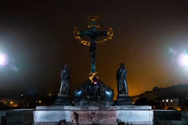 Photo of Significant monument - statue of crucified Christ on Charles bridge in Prague.