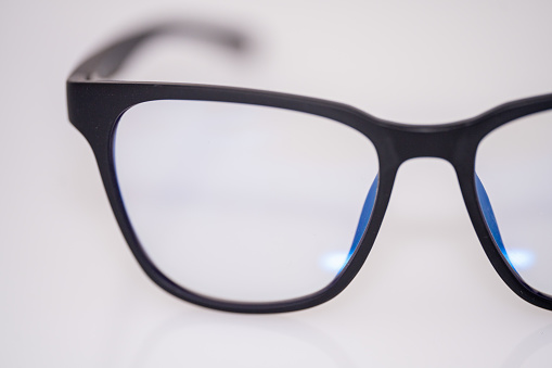 A pair of blue light glasses on a white background
